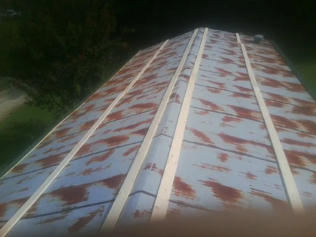 Rusted metal roof panels with new wood purlins before replacement — Storm Damage Roof Repair in Arcadia by Roofing Brothers