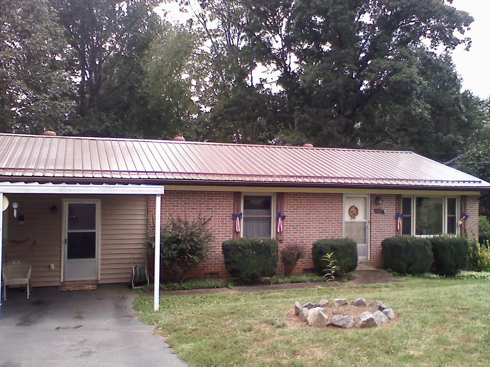 Bronze metal roof and carport on a brick ranch home — Roof Repair work by our crew in Arcadia